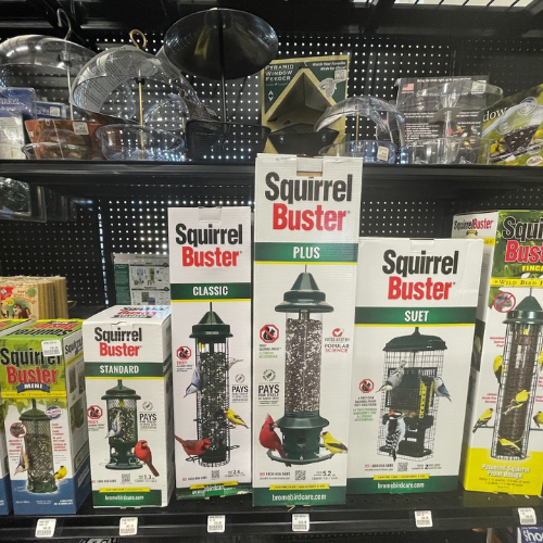 Display of wild bird feed and supplies, including Squirrel Buster bird feeders, at Mechanicsburg Agway.