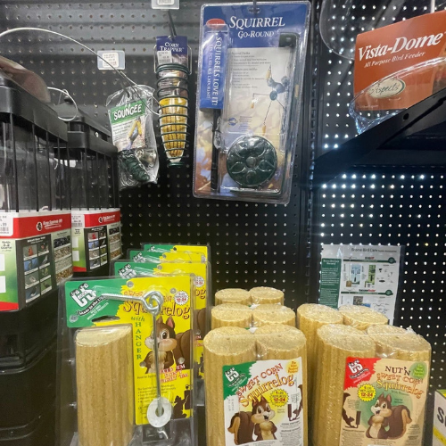 Display of wild bird feed and supplies, including Squirrel Go-Rounds and Squirrelogs, at Mechanicsburg Agway.